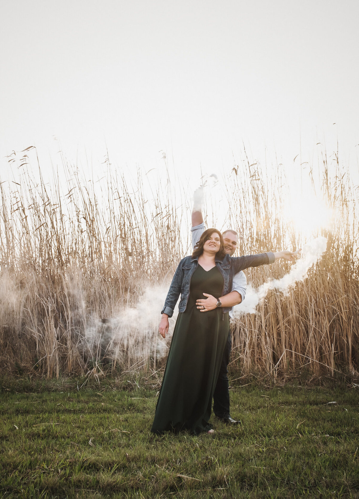 Smoke bombs and couple arms waving with their engagement shoot at Rietvlei Dam in Irene