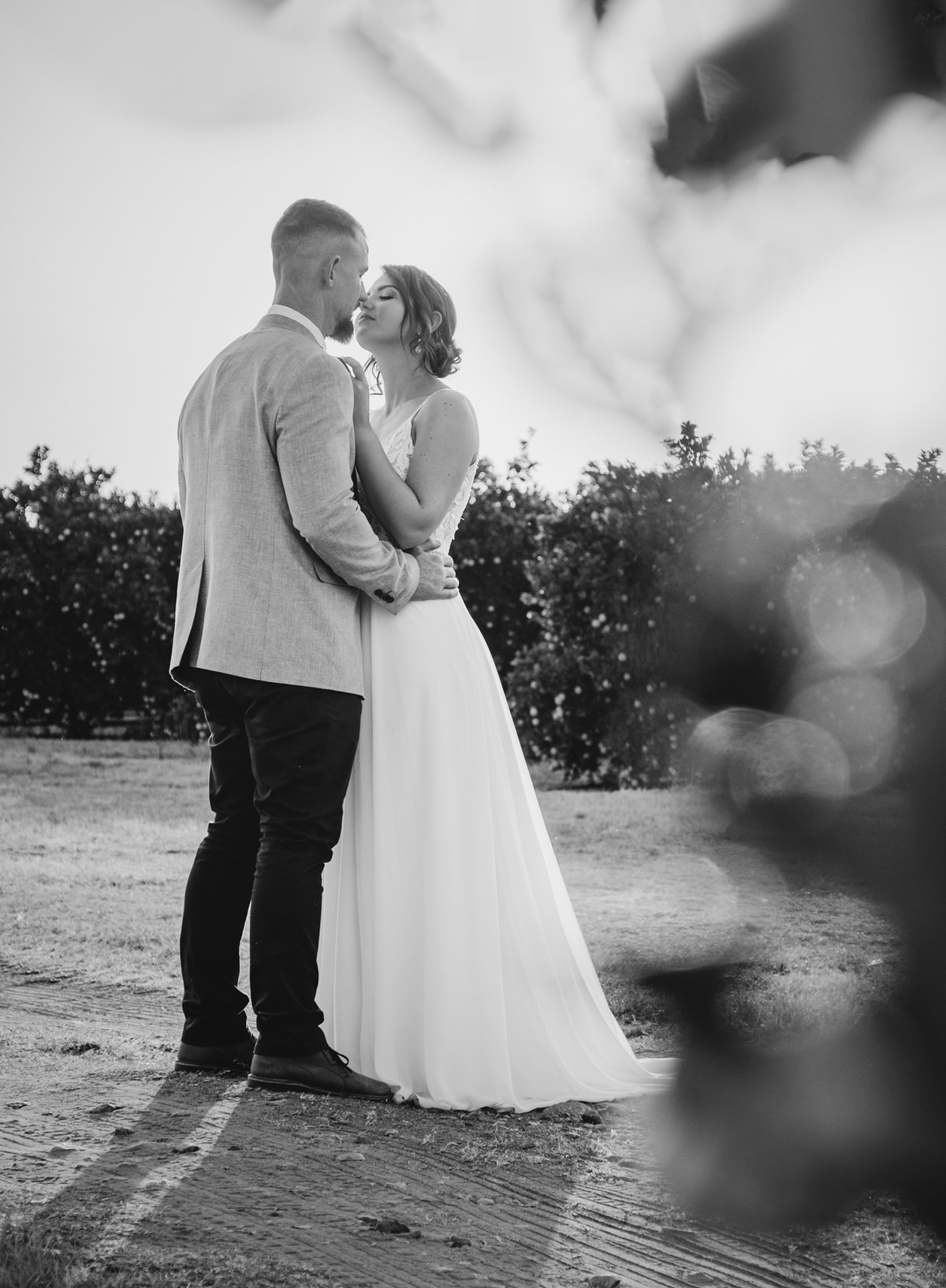 Photo by Lynette van der Bijl Black and white photo of bride and groom with bokeh bubbles in front of them.