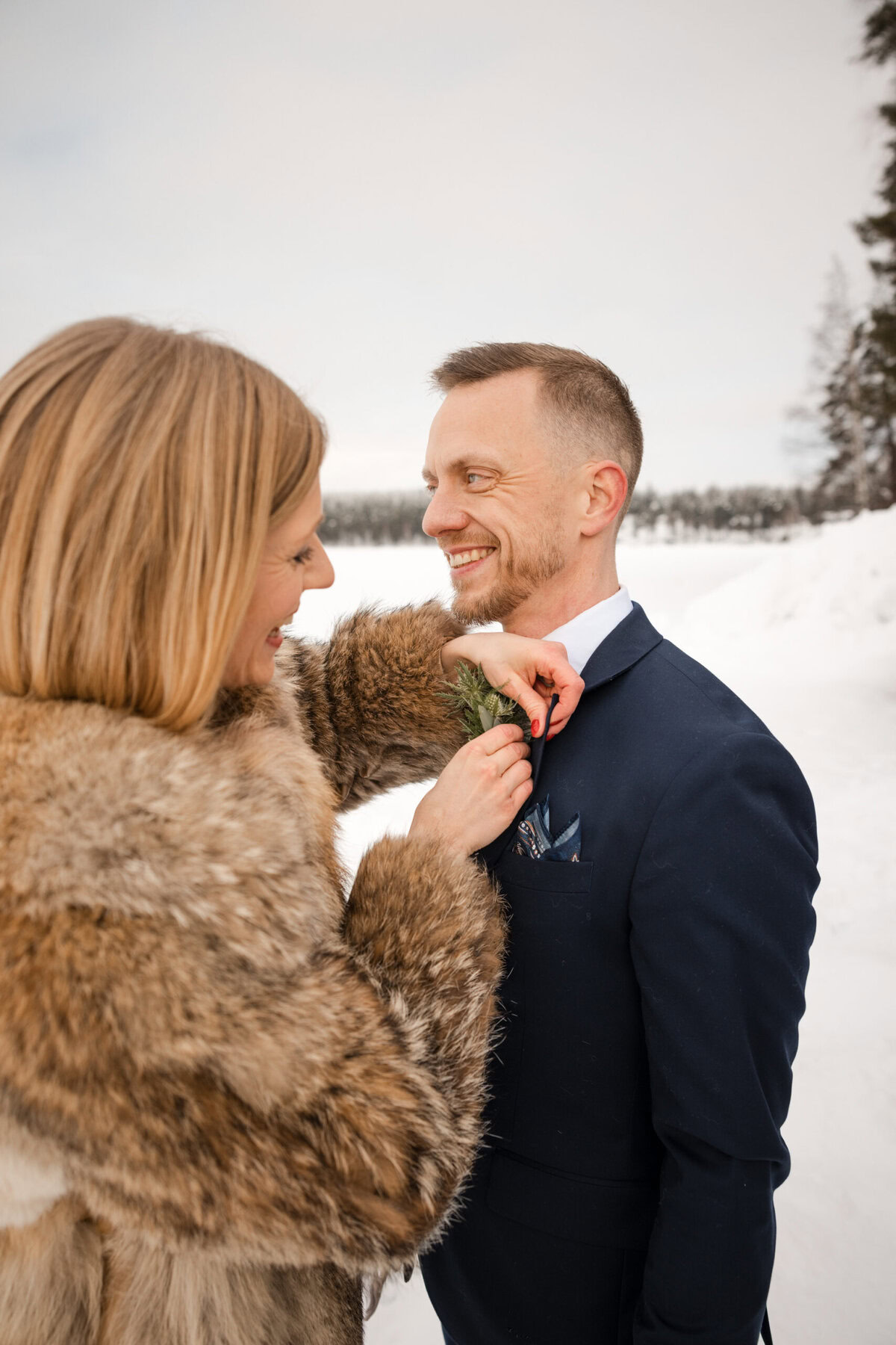 Couple preparing for a winter wedding.